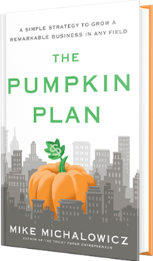 white book cover with a large orange pumpkin juxtaposed within a grey city skyline and The Pumpkin Plan written above in green text